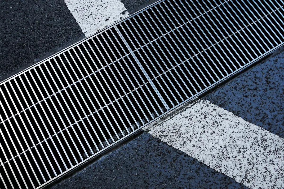 Metallrost einer Entwässerungsrinne in einer Fläche